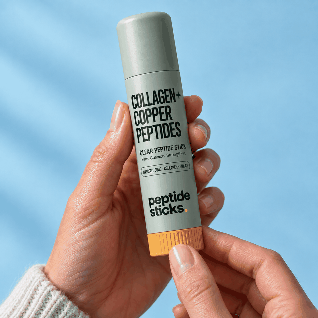 A hand holding the Peptide Sticks™ Collagen + Copper Stick